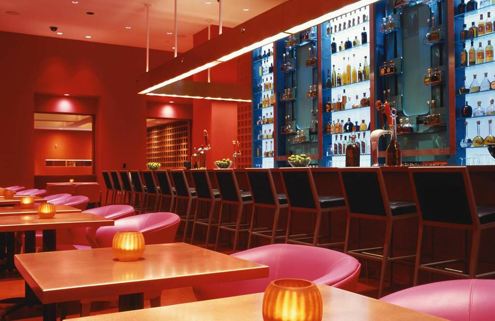 Restaurant bar with pink chairs and tables