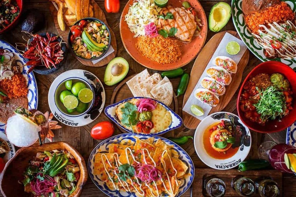 Variety of mexican cuisine dishes. Includes tacos, nachos and fajitas